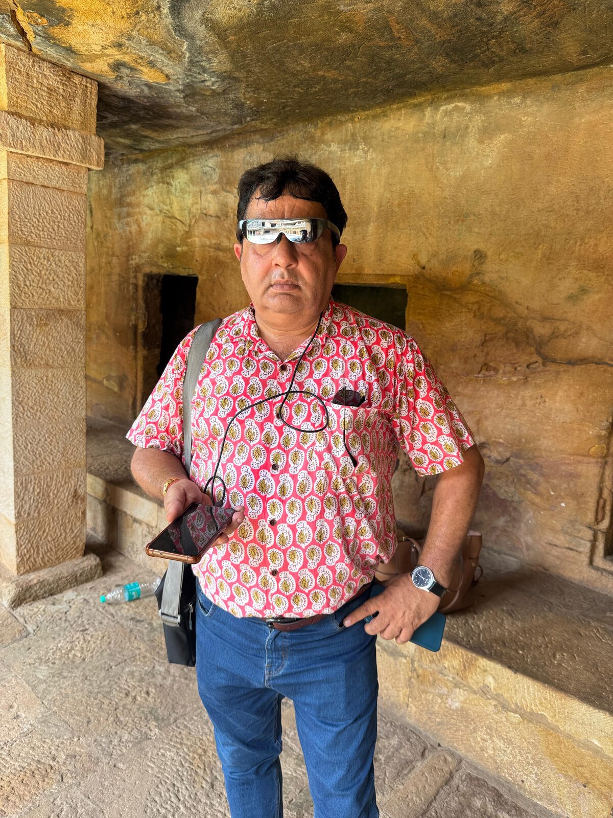 Visitor wearing AR glasses inside Khandagiri cave